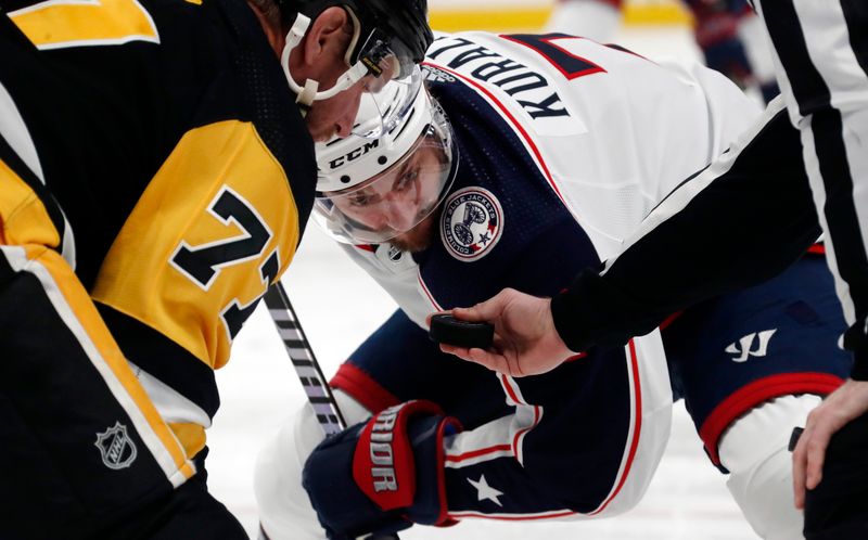 Mar 5, 2024; Pittsburgh, Pennsylvania, USA; Columbus Blue Jackets center Sean Kuraly (7) waits for the puck drop on a face-off against Pittsburgh Penguins center Jeff Carter (77) during the second period at PPG Paints Arena. The Penguins won 5-3. Mandatory Credit: Charles LeClaire-USA TODAY Sports