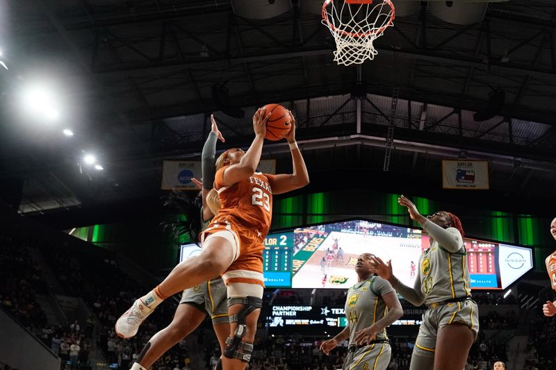 Feb 1, 2024; Waco, Texas, USA; Texas Longhorns forward Aaliyah Moore (23) scores a layup past Baylor Lady Bears forward Dre'Una Edwards (44) during the first half at Paul and Alejandra Foster Pavilion. Mandatory Credit: Chris Jones-USA TODAY Sports