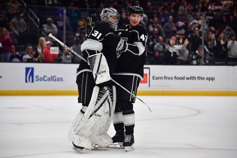 Mar 20, 2024; Los Angeles, California, USA; Los Angeles Kings goaltender David Rittich (31) and defenseman Jacob Moverare (43) celebrate the victory against the Minnesota Wild at Crypto.com Arena. Mandatory Credit: Gary A. Vasquez-USA TODAY Sports