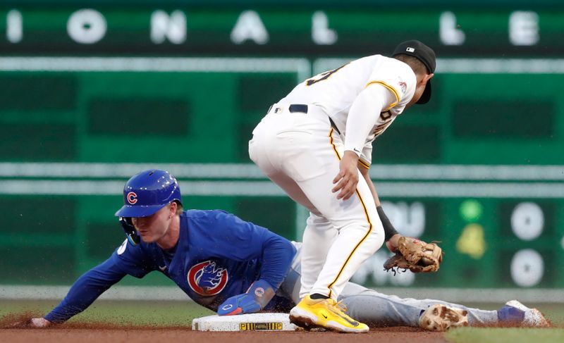 Aug 26, 2024; Pittsburgh, Pennsylvania, USA;  Chicago Cubs center fielder Pete Crow-Armstrong (52) steals second base against a late tag by Pittsburgh Pirates second baseman Nick Gonzalez (right)  during the fourth inning at PNC Park. Mandatory Credit: Charles LeClaire-USA TODAY Sports