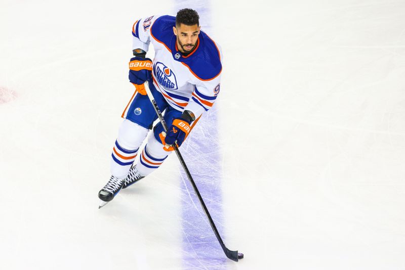 Apr 6, 2024; Calgary, Alberta, CAN; Edmonton Oilers left wing Evander Kane (91) skates with the puck during the warmup period against the Calgary Flames at Scotiabank Saddledome. Mandatory Credit: Sergei Belski-USA TODAY Sports