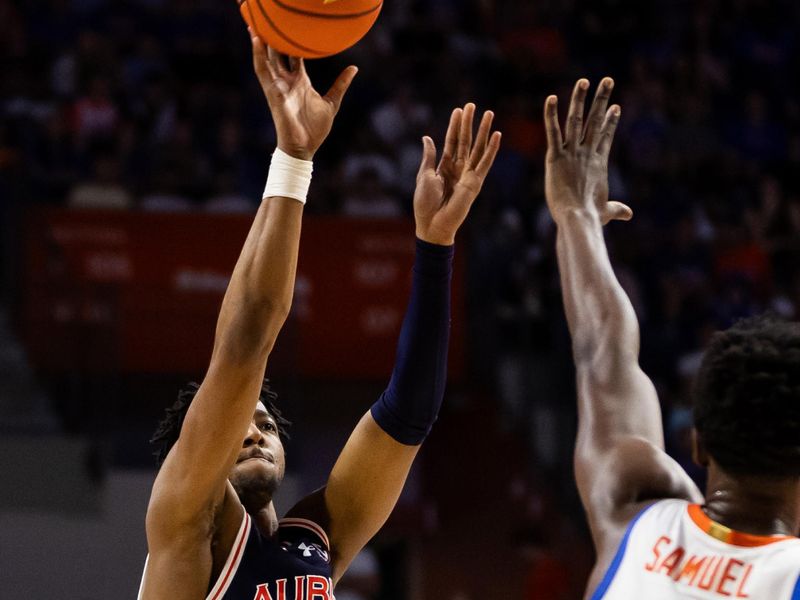 Feb 10, 2024; Gainesville, Florida, USA; Auburn Tigers guard Chaney Johnson (31) shoots over Florida Gators forward Tyrese Samuel (4) during the first half at Exactech Arena at the Stephen C. O'Connell Center. Mandatory Credit: Matt Pendleton-USA TODAY Sports