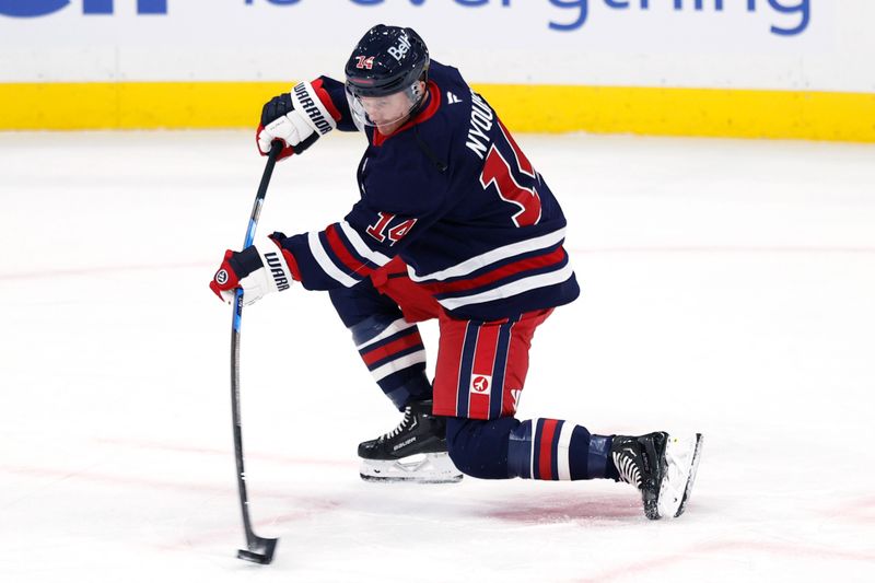 Oct 23, 2025; Winnipeg, Manitoba, CAN; Winnipeg Jets right wing Gustav Nyquist (14) warms up before a game against the Seattle Kraken at Canada Life Centre. Mandatory Credit: James Carey Lauder-Imagn Images