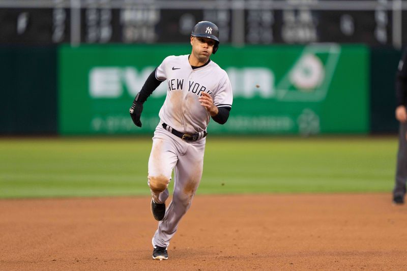 Jun 28, 2023; Oakland, California, USA;  New York Yankees center fielder Isiah Kiner-Falefa (12) runs towards third base during the fifth inning against the Oakland Athletics at Oakland-Alameda County Coliseum. Mandatory Credit: Stan Szeto-USA TODAY Sports