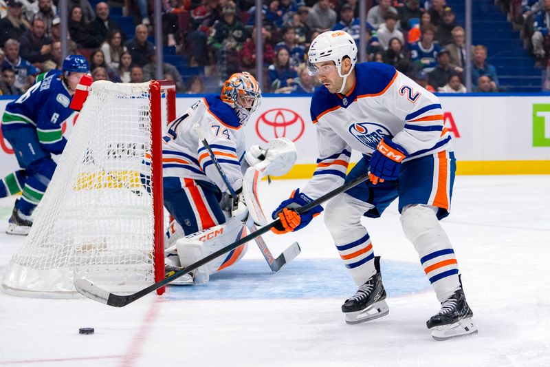 Oct 4, 2024; Vancouver, British Columbia, CAN; Edmonton Oilers defenseman Evan Bouchard (2) handles the puck against the Vancouver Canucks during the third period at Rogers Arena. Mandatory Credit: Bob Frid-Imagn Images