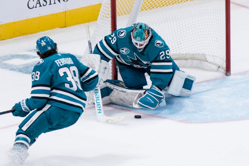 Nov 23, 2024; San Jose, California, USA; San Jose Sharks goaltender Mackenzie Blackwood (29) saves a shot by a Buffalo Sabres player during the third period at SAP Center in San Jose. Mandatory Credit: John Hefti-Imagn Images