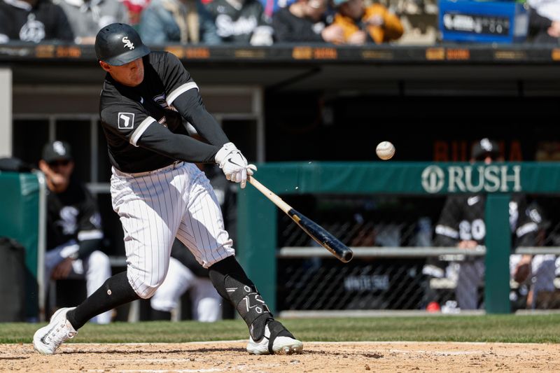 Apr 6, 2023; Chicago, Illinois, USA; Chicago White Sox first baseman Andrew Vaughn (25) hits an RBI single against the San Francisco Giants during the fourth inning at Guaranteed Rate Field. Mandatory Credit: Kamil Krzaczynski-USA TODAY Sports