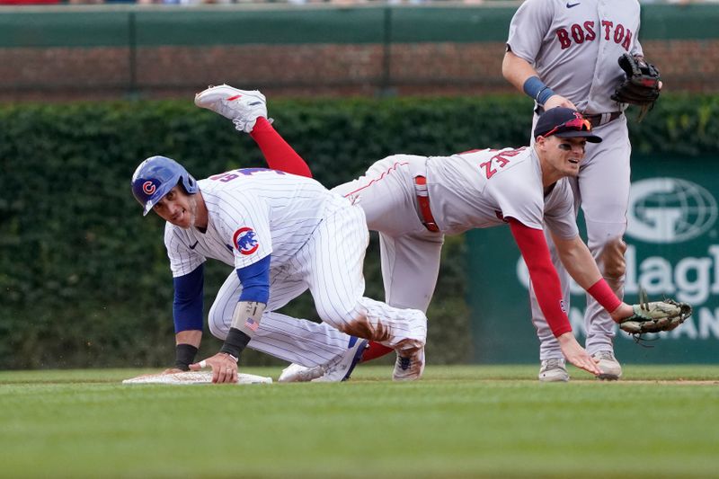 Jul 15, 2023; Chicago, Illinois, USA; Boston Red Sox shortstop Enrique Hernandez (5) forces out Chicago Cubs catcher Yan Gomes (15) at second base during the third inning at Wrigley Field. Mandatory Credit: David Banks-USA TODAY Sports