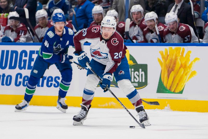 Mar 13, 2024; Vancouver, British Columbia, CAN; Colorado Avalanche forward Ross Colton (20) handles the puck against the Vancouver Canucks in the first period at Rogers Arena. Mandatory Credit: Bob Frid-USA TODAY Sports