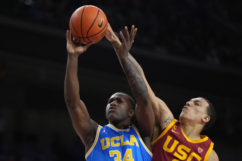 Jan 26, 2023; Los Angeles, California, USA; Southern California Trojans forward Kobe Johnson (0) blocks a shot by UCLA Bruins guard Jaime Jaquez Jr. (24) in the first half at Galen Center. Mandatory Credit: Kirby Lee-USA TODAY Sports