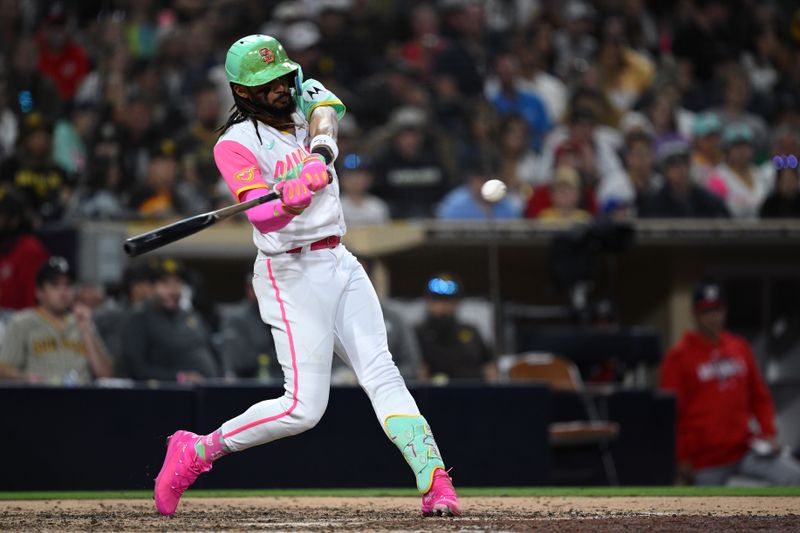 Jun 23, 2023; San Diego, California, USA; San Diego Padres right fielder Fernando Tatis Jr. (23) hits a double against the Washington Nationals during the eighth inning at Petco Park. Mandatory Credit: Orlando Ramirez-USA TODAY Sports