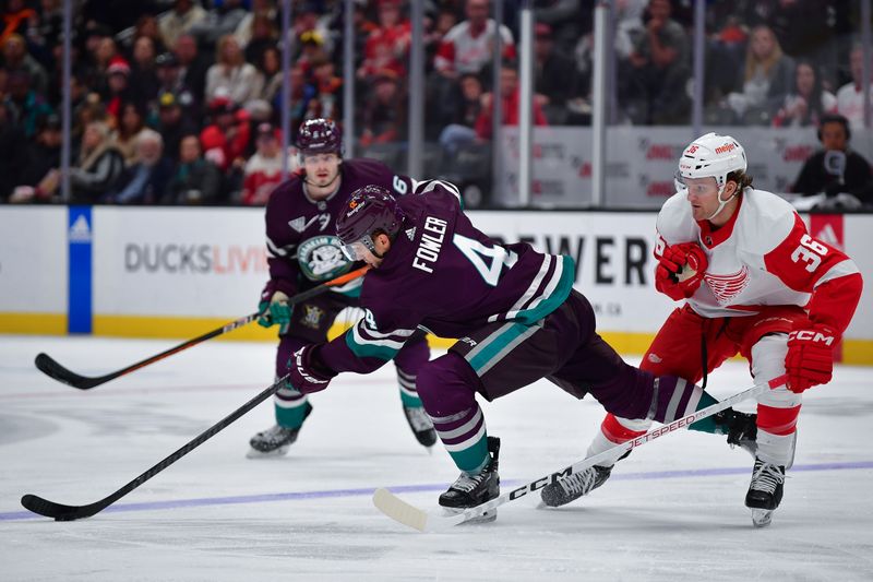 Jan 7, 2024; Anaheim, California, USA; Anaheim Ducks defenseman Cam Fowler (4) moves the puck against Detroit Red Wings right wing Christian Fischer (36) during the second period at Honda Center. Mandatory Credit: Gary A. Vasquez-USA TODAY Sports