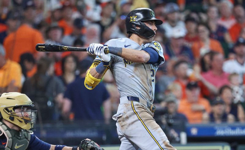 May 19, 2024; Houston, Texas, USA; Milwaukee Brewers designated hitter Christian Yelich (22) hits an RBI sinlge during the seventh inning against the Houston Astros at Minute Maid Park. Mandatory Credit: Troy Taormina-USA TODAY Sports