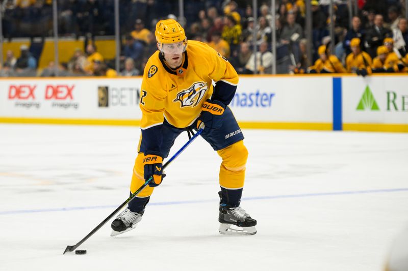 Jan 14, 2025; Nashville, Tennessee, USA;  Nashville Predators defenseman Luke Schenn (2) skates with the puck against the Vegas Golden Knights during the first period at Bridgestone Arena. Mandatory Credit: Steve Roberts-Imagn Images