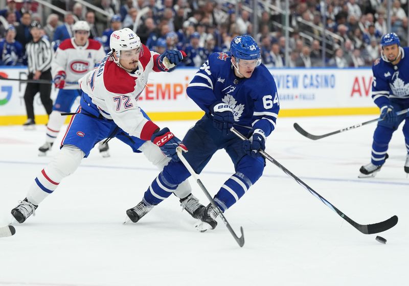 Oct 11, 2023; Toronto, Ontario, CAN; Montreal Canadiens defenseman Arber Xhekaj (72) battles for the puck with Toronto Maple Leafs center David Kampf (64) during the third period at Scotiabank Arena. Mandatory Credit: Nick Turchiaro-USA TODAY Sports