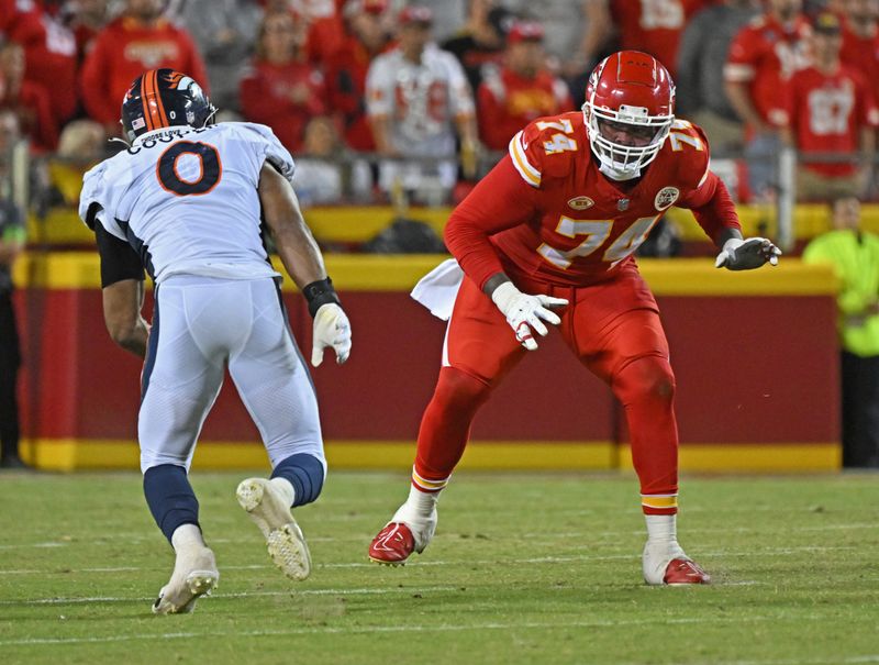 Kansas City Chiefs offensive tackle Jawaan Taylor (74) gets set to block Denver Broncos linebacker Jonathon Cooper (0)during the second half of an NFL football game Thursday, Oct. 12, 2023, in Kansas City, Mo. (AP Photo/Peter Aiken)