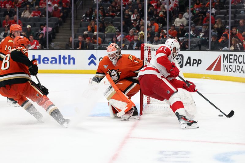 Oct 31, 2025; Anaheim, California, USA;  Detroit Red Wings center Dylan Larkin (71) controls the puck against Anaheim Ducks goaltender Lukas Dostal (1) during the third period at Honda Center. Mandatory Credit: Kiyoshi Mio-Imagn Images