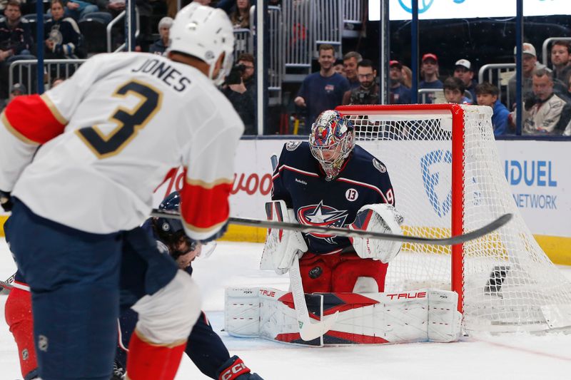 Mar 20, 2025; Columbus, Ohio, USA; Columbus Blue Jackets goalie Elvis Merzlikins (90) makes a save on the shot attempt of Florida Panthers defenseman Seth Jones (3) during the first period at Nationwide Arena. Mandatory Credit: Russell LaBounty-Imagn Images