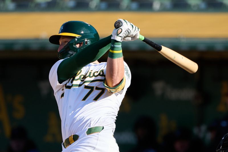 May 4, 2024; Oakland, California, USA; Oakland Athletics infielder Brett Harris (77) hits a one-run home run against the Miami Marlins for his first MLB career hit during the fourth inning at Oakland-Alameda County Coliseum. Mandatory Credit: Robert Edwards-USA TODAY Sports