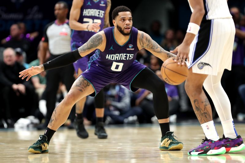 CHARLOTTE, NORTH CAROLINA - MARCH 05: Miles Bridges #0 of the Charlotte Hornets defends Paolo Banchero #5 of the Orlando Magic during the first half of an NBA game at Spectrum Center on March 05, 2024 in Charlotte, North Carolina. NOTE TO USER: User expressly acknowledges and agrees that, by downloading and or using this photograph, User is consenting to the terms and conditions of the Getty Images License Agreement. (Photo by David Jensen/Getty Images)