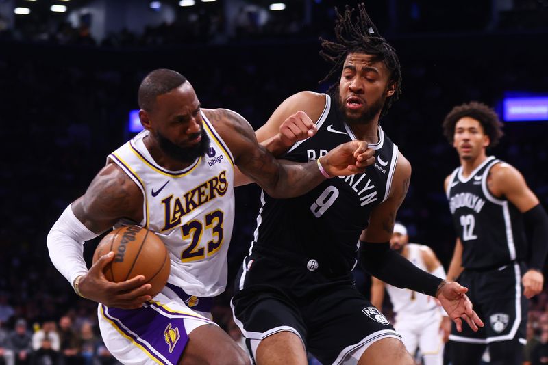 NEW YORK, NEW YORK - MARCH 31: LeBron James #23 of the Los Angeles Lakers drives to the net against Trendon Watford #9 of the Brooklyn Nets at Barclays Center on March 31, 2024 in New York City. NOTE TO USER: User expressly acknowledges and agrees that, by downloading and or using this photograph, User is consenting to the terms and conditions of the Getty Images License Agreement. (Photo by Mike Stobe/Getty Images)