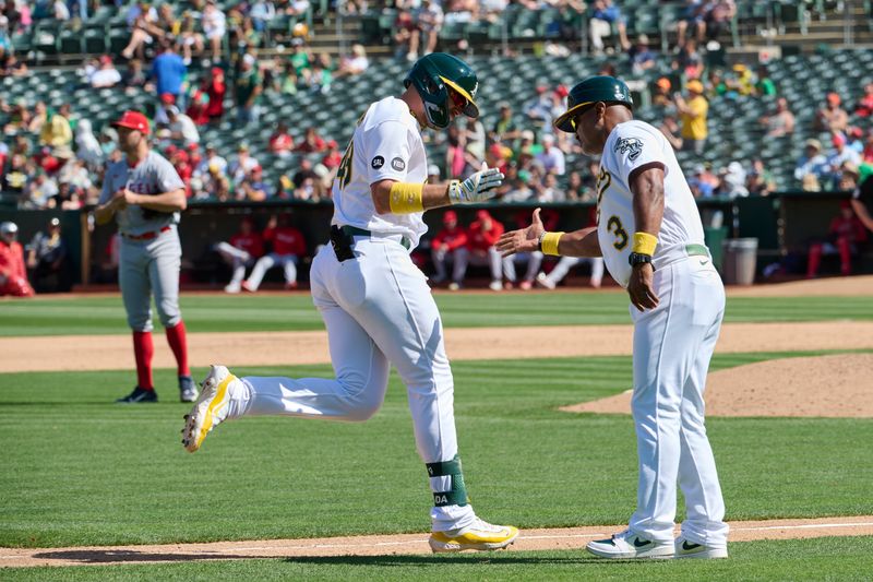 Sep 3, 2023; Oakland, California, USA; Oakland Athletics infielder Ryan Noda (49) shakes hands with third base coach Eric Martins (3) after hitting a two run home run against the Los Angeles Angels during the sixth inning at Oakland-Alameda County Coliseum. Mandatory Credit: Robert Edwards-USA TODAY Sports