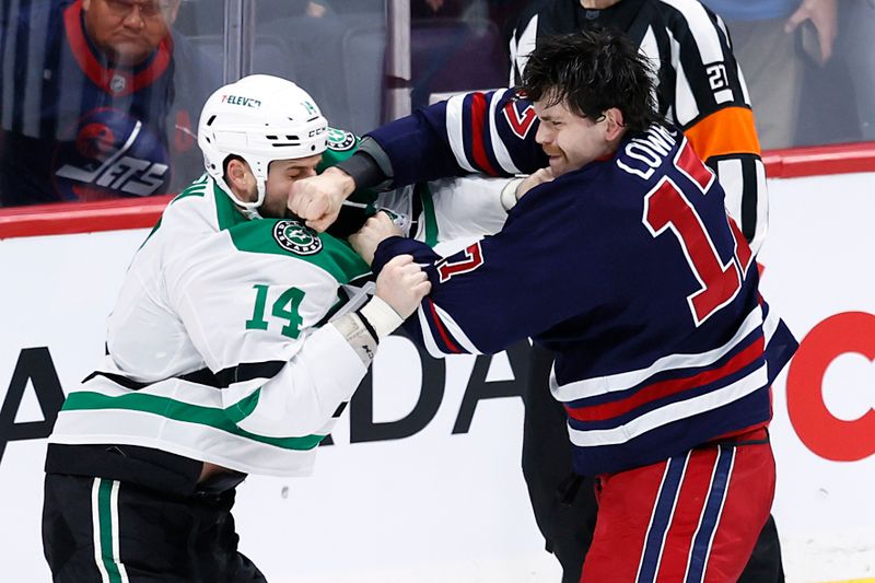 Nov 9, 2024; Winnipeg, Manitoba, CAN; Dallas Stars left wing Jamie Benn (14) and Winnipeg Jets center Adam Lowry (17) fight in the third period at Canada Life Centre. Mandatory Credit: James Carey Lauder-Imagn Images