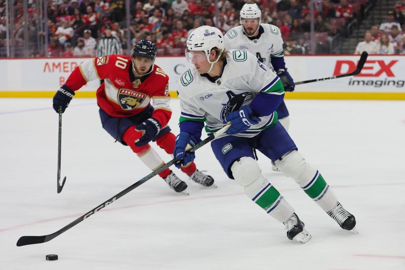 Oct 17, 2024; Sunrise, Florida, USA; Vancouver Canucks right wing Brock Boeser (6) moves the puck against the Florida Panthers during the second period at Amerant Bank Arena. Mandatory Credit: Sam Navarro-Imagn Images