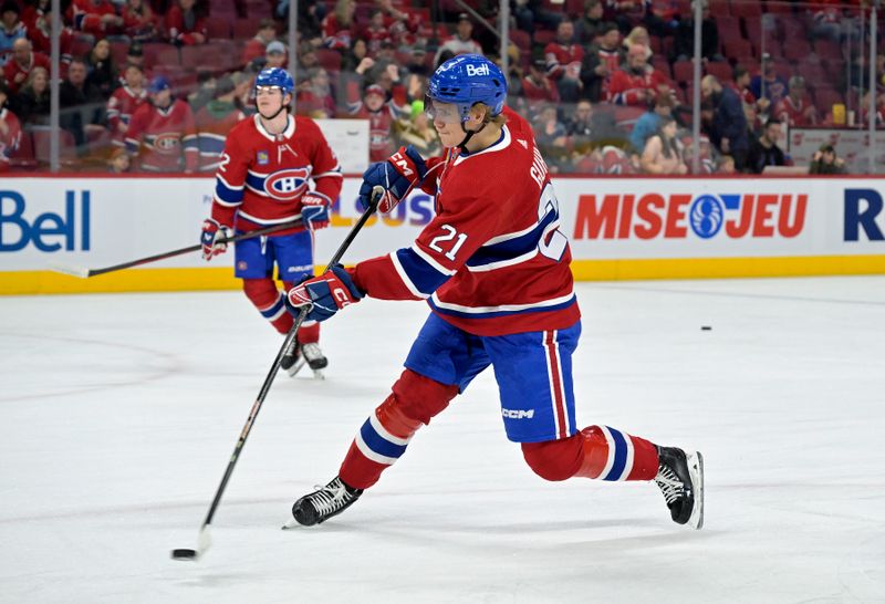 Feb 11, 2024; Montreal, Quebec, CAN; Montreal Canadiens defenseman Kaiden Guhle (21) takes a shot on net during the warmup period before the game against the St.Louis Blues at the Bell Centre. Mandatory Credit: Eric Bolte-USA TODAY Sports