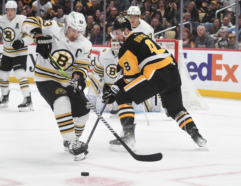 Apr 13, 2024; Pittsburgh, Pennsylvania, USA; Boston Bruins center left wing Brad Marchand (63) plays the puck in front of Pittsburgh Penguins left wing Michael Bunting (8) during the first period at PPG Paints Arena. Mandatory Credit: Philip G. Pavely-USA TODAY Sports