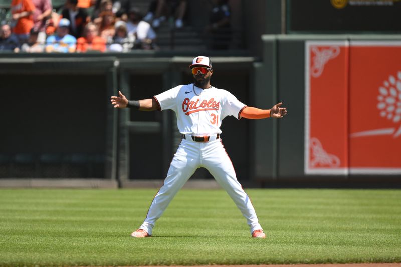 Apr 28, 2024; Baltimore, Maryland, USA;  Baltimore Orioles center fielder Cedric Mullins (31) stretches on the field prior to the game between the Baltimore Orioles and the Oakland Athletics at Oriole Park at Camden Yards. Mandatory Credit: James A. Pittman-USA TODAY Sports