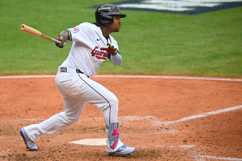 Oct 12, 2024; Cleveland, Ohio, USA; Cleveland Guardians third base Jose Ramirez (11) hits a single in the seventh inning against the Detroit Tigers during game five of the ALDS for the 2024 MLB Playoffs at Progressive Field. Mandatory Credit: David Richard-Imagn Images