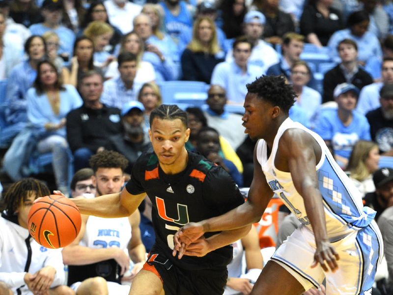 Feb 13, 2023; Chapel Hill, North Carolina, USA; Miami (Fl) Hurricanes guard Isaiah Wong (2) with the ball as North Carolina Tar Heels guard D'Marco Dunn (11) defends in the first half at Dean E. Smith Center. Mandatory Credit: Bob Donnan-USA TODAY Sports