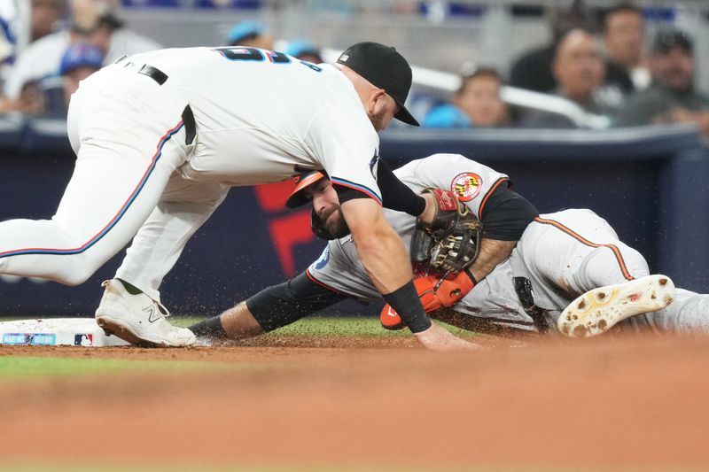 Jul 23, 2024; Miami, Florida, USA;  Miami Marlins third baseman Jake Burger (36) tags out Baltimore Orioles left fielder Colton Cowser (17) in the third inning at loanDepot Park. Mandatory Credit: Jim Rassol-USA TODAY Sports