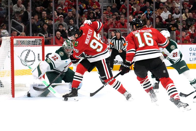Nov 26, 2025; Chicago, Illinois, USA; Chicago Blackhawks right wing Ilya Mikheyev (95) tries to shoot the puck on Minnesota Wild goaltender Filip Gustavsson (32) during the second period at United Center. Mandatory Credit: David Banks-Imagn Images