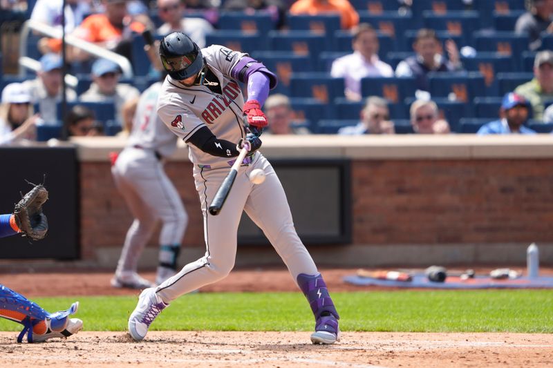May 1, 2025; New York City, New York, USA; Arizona Diamondbacks left fielder Lourdes Gurriel Jr. (12) hits a single against the New York Mets during the fourth inning at Citi Field. Mandatory Credit: Gregory Fisher-Imagn Images