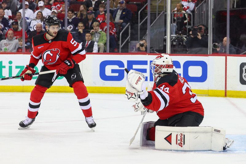 Mar 21, 2024; Newark, New Jersey, USA; New Jersey Devils goaltender Jake Allen (34) makes a save against the Winnipeg Jets during the first period at Prudential Center. Mandatory Credit: Ed Mulholland-USA TODAY Sports