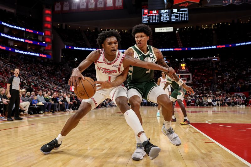 HOUSTON, TEXAS - JANUARY 06: Amen Thompson #1 of the Houston Rockets goes to the basket while defended by MarJon Beauchamp #3 of the Milwaukee Bucks in the first half at Toyota Center on January 06, 2024 in Houston, Texas.  NOTE TO USER: User expressly acknowledges and agrees that, by downloading and or using this photograph, User is consenting to the terms and conditions of the Getty Images License Agreement. (Photo by Tim Warner/Getty Images)