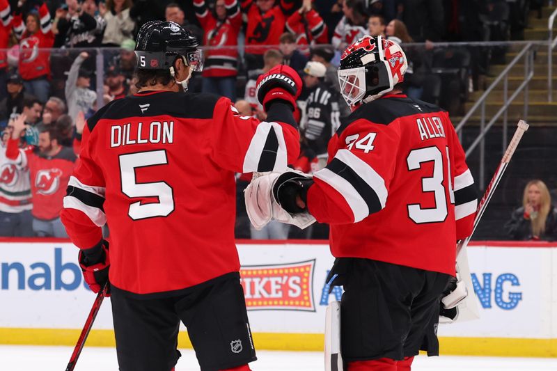 Oct 24, 2025; Newark, New Jersey, USA; New Jersey Devils defenseman Brenden Dillon (5) and goaltender Jake Allen (34) celebrate the Devils win over the San Jose Sharks at Prudential Center. Mandatory Credit: Ed Mulholland-Imagn Images