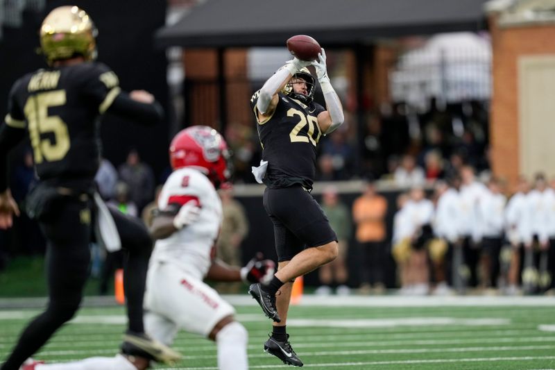 Nov 11, 2023; Winston-Salem, North Carolina, USA; Wake Forest Demon Deacons quarterback Michael Kern (15) watches his pass caught by tight end Cameron Hite (20) against the North Carolina State Wolfpack during the second half at Allegacy Federal Credit Union Stadium. Mandatory Credit: Jim Dedmon-USA TODAY Sports