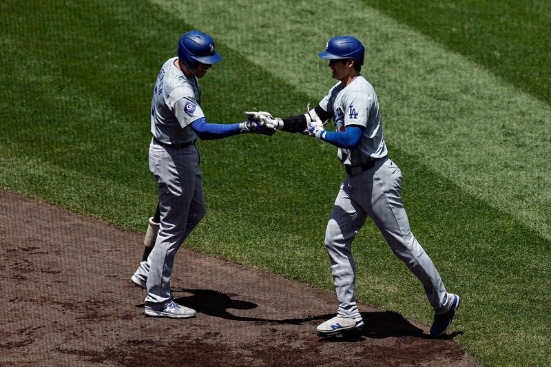 Jun 20, 2024; Denver, Colorado, USA; Los Angeles Dodgers designated hitter Shohei Ohtani (17) celebrates his solo home run with first baseman Freddie Freeman (5) in the first inning against the Colorado Rockies at Coors Field. Mandatory Credit: Isaiah J. Downing-USA TODAY Sports