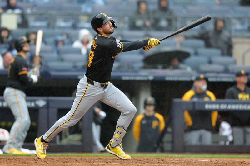 Sep 28, 2024; Bronx, New York, USA; Pittsburgh Pirates first baseman Jared Triolo (19) follows through on a two run home run against the New York Yankees during the sixth inning at Yankee Stadium. Mandatory Credit: Brad Penner-Imagn Images