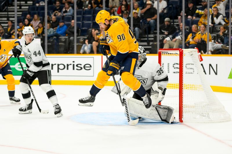 Nov 4, 2024; Nashville, Tennessee, USA;  Los Angeles Kings goaltender Darcy Kuemper (35) blocks the shot of from Nashville Predators left wing Filip Forsberg (9) as Nashville Predators center Ryan O'Reilly (90) jumps during the third period at Bridgestone Arena. Mandatory Credit: Steve Roberts-Imagn Images