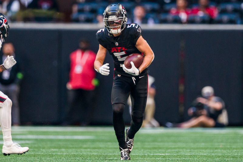 Atlanta Falcons wide receiver Drake London (5) runs the ball during the second half of an NFL football game against the Houston Texans, Sunday, Oct. 8, 2023, in Atlanta. The Atlanta Falcons won 21-19. (AP Photo/Danny Karnik)