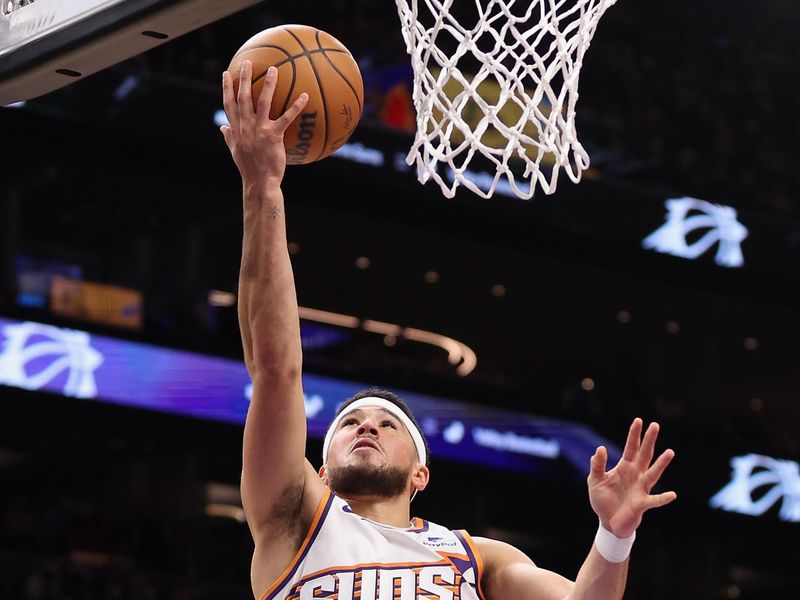 PHOENIX, ARIZONA - DECEMBER 25: Devin Booker #1 of the Phoenix Suns lays up a shot against the Dallas Mavericks during the second half of the NBA game at Footprint Center on December 25, 2023 in Phoenix, Arizona. The Mavericks defeated the Suns 128-114. NOTE TO USER: User expressly acknowledges and agrees that, by downloading and or using this photograph, User is consenting to the terms and conditions of the Getty Images License Agreement.  (Photo by Christian Petersen/Getty Images)