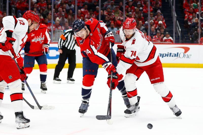 Mar 22, 2024; Washington, District of Columbia, USA; Washington Capitals defenseman John Carlson (74) battles for the puck with Carolina Hurricanes defenseman Jaccob Slavin (74) during the second period at Capital One Arena. Mandatory Credit: Amber Searls-USA TODAY Sports