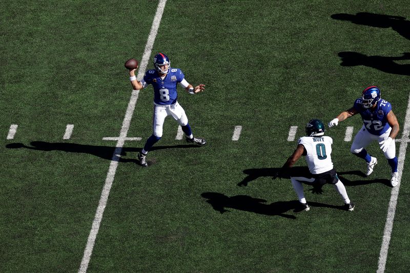 New York Giants quarterback Daniel Jones (8) passes the ball during an NFL football game against the Philadelphia Eagles Sunday, Oct. 20, 2024, in East Rutherford, N.J. (AP Photo/Adam Hunger)