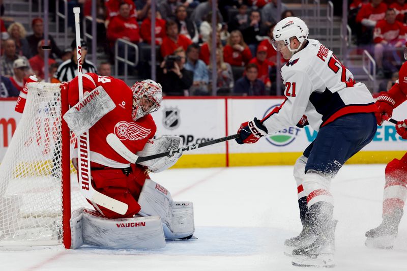 Apr 9, 2024; Detroit, Michigan, USA; Detroit Red Wings goaltender Alex Lyon (34) makes a save on Washington Capitals center Aliaksei Protas (21) in the first period at Little Caesars Arena. Mandatory Credit: Rick Osentoski-USA TODAY Sports