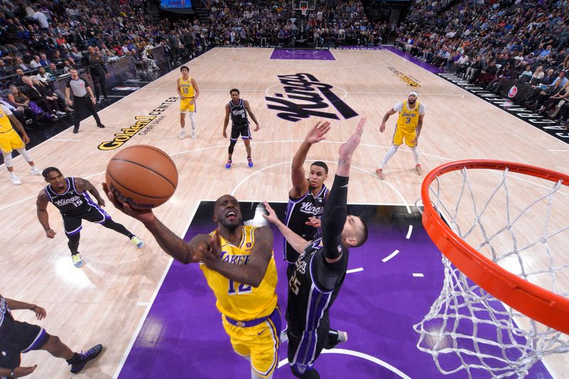 SACRAMENTO, CA - MARCH 13: Taurean Prince #12 of the Los Angeles Lakers to the basket during the game against the Sacramento Kings on March 13, 2024 at Golden 1 Center in Sacramento, California. NOTE TO USER: User expressly acknowledges and agrees that, by downloading and or using this Photograph, user is consenting to the terms and conditions of the Getty Images License Agreement. Mandatory Copyright Notice: Copyright 2024 NBAE (Photo by Rocky Widner/NBAE via Getty Images)