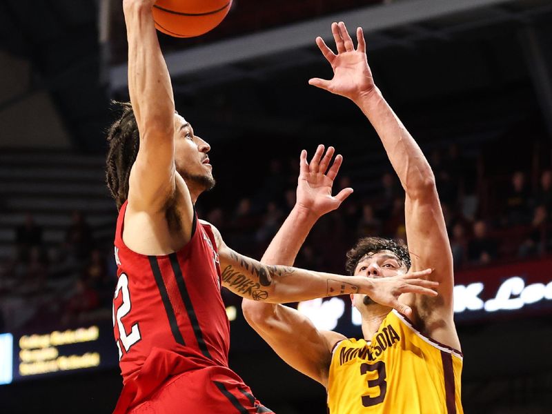 Mar 2, 2023; Minneapolis, Minnesota, USA; Rutgers Scarlet Knights guard Caleb McConnell (22) drives to the basket while Minnesota Golden Gophers forward Dawson Garcia (3) defends during the second half at Williams Arena. Mandatory Credit: Matt Krohn-USA TODAY Sports